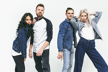 Image showing Group of smiling friends in fashionable jeans