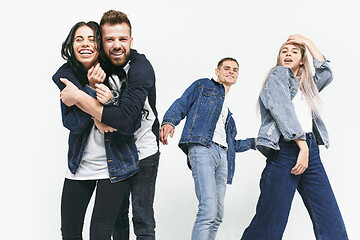 Image showing Group of smiling friends in fashionable jeans