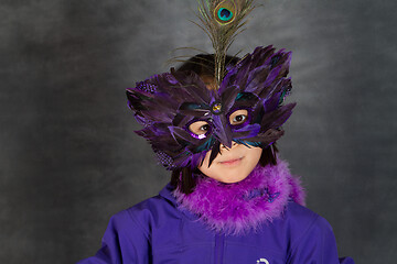 Image showing Portrait of a young cute girl with a mask  looking at the camera