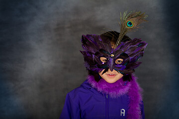 Image showing Portrait of a young cute girl with a mask  looking at the camera