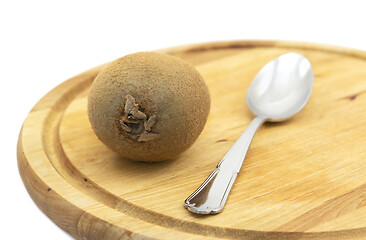 Image showing Fresh kiwi fruit with a spoon on a wooden board