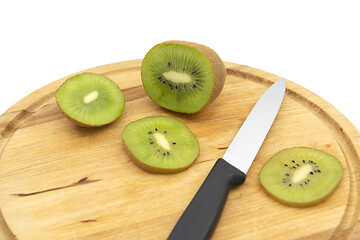 Image showing Fresh green kiwi with a kitchen knife and cut slices