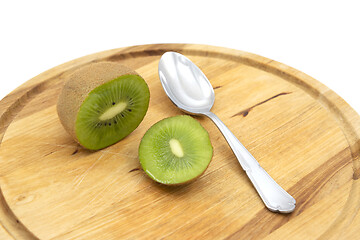 Image showing Whole fresh kiwifruit cut open, to be eaten with a spoon