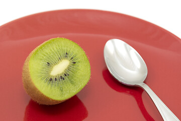 Image showing Half kiwi fruit ready to eat with a spoon