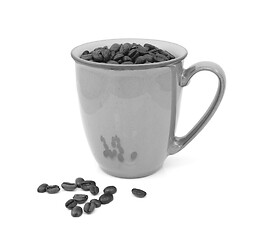 Image showing Coffee beans in a mug and spilled beside