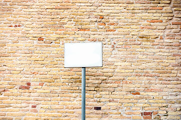 Image showing typical red brick wall background with blank white plaque