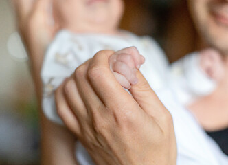 Image showing Infant boy in the arms of dad