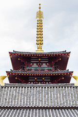 Image showing Top of pagoda tower on light background with clouds