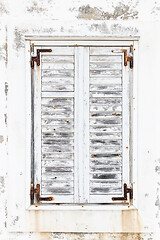 Image showing White weathered rusted wooden window shutters.