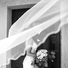 Image showing The kiss. Bride and groom kisses tenderly in the shadow of a flying veil. Artistic black and white wedding photo.