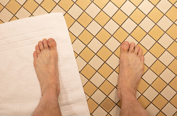 Image showing After taking a shower; Male feet on a vintage bathroom floor