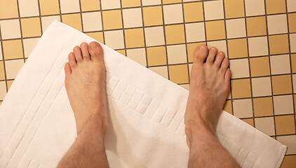 Image showing After taking a shower; Male feet on a vintage bathroom floor