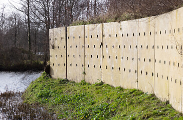 Image showing Wall with holes, nests for swallows