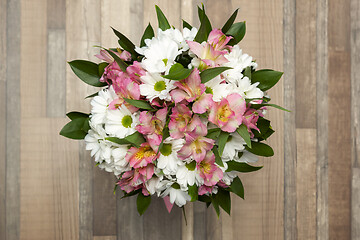 Image showing Beautiful bouquet of fresh flowers on a wooden background