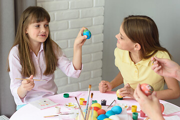 Image showing Girl shows sister how she painted an Easter egg