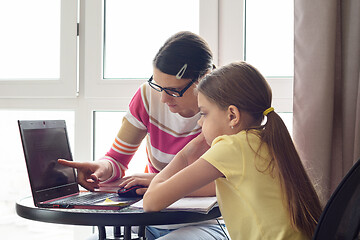 Image showing Girl helps girl figure out how to use the Internet