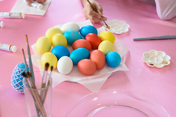 Image showing Coloring Easter eggs, multi-colored eggs in the middle of the table