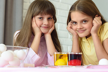 Image showing Two girls are waiting for the eggs to be painted in different colors for the Easter holiday.