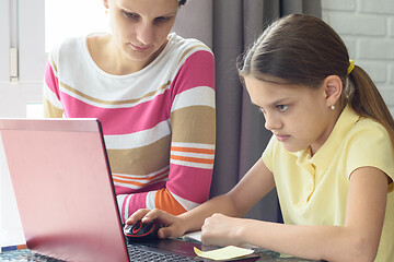 Image showing Girl focused on homework online