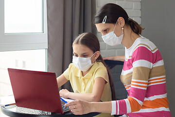 Image showing quarantined girl and girl perform school tasks online