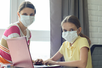 Image showing Quarantine mom and daughter do home lessons online