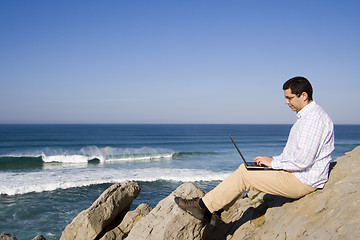 Image showing Working with the laptop at the beach