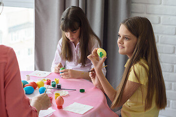 Image showing Child shows mom painted easter egg