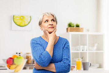 Image showing portrait of senior woman thinking in kitchen