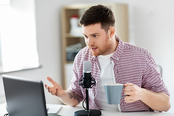 Image showing blogger with laptop and microphone audio blogging