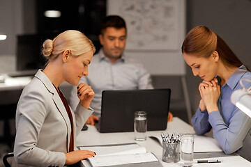 Image showing business team with laptop working at night office