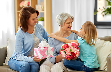 Image showing granddaughter hugging and greeting grandmother