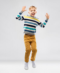 Image showing happy little boy jumping and having fun