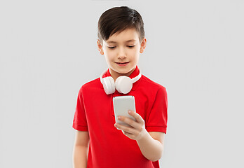 Image showing boy in red t-shirt with headphones and smartphone