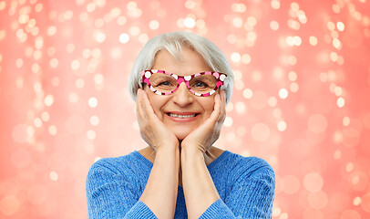 Image showing amazed funny senior woman with big party glasses