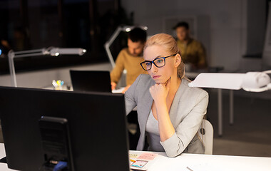 Image showing tired businesswoman working at night office