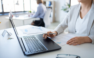 Image showing businesswoman with laptop working at office