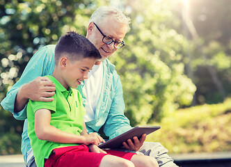 Image showing happy grandfather and boy with tablet pc outdoors