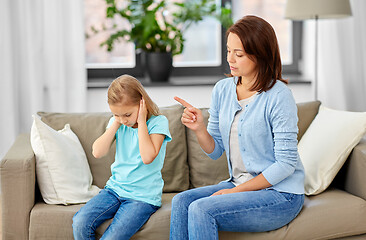 Image showing angry mother scolding her daughter at home