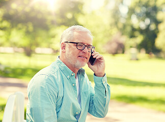 Image showing senior man calling on smartphone at summer park