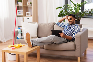 Image showing man with tablet computer after home cleaning