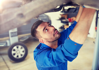 Image showing mechanic man or smith repairing car at workshop