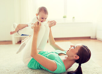 Image showing happy mother playing with baby at home