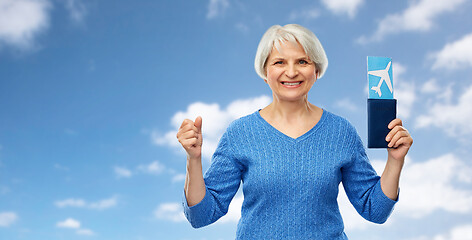 Image showing senior woman with passport and airplane ticket