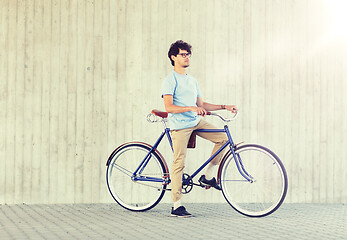 Image showing young hipster man riding fixed gear bike