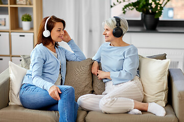 Image showing senior mother and adult daughter with headphones