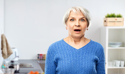 Image showing shocked senior woman with open mouth at kitchen