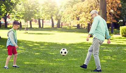 Image showing old man and boy playing football at summer park