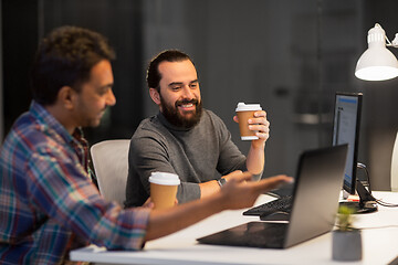 Image showing creative team drinking coffee at night office