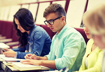 Image showing group of students with books writing at lecture