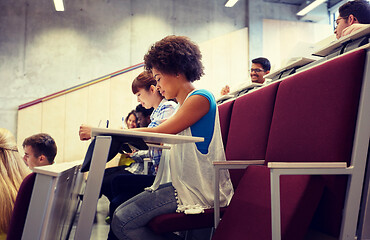 Image showing group of students with notebooks at lecture hall